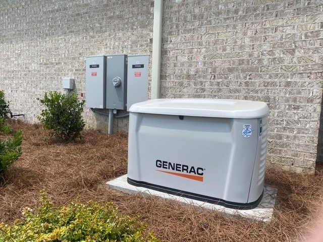 Generac generator installed against a brick wall with transfer switch panels